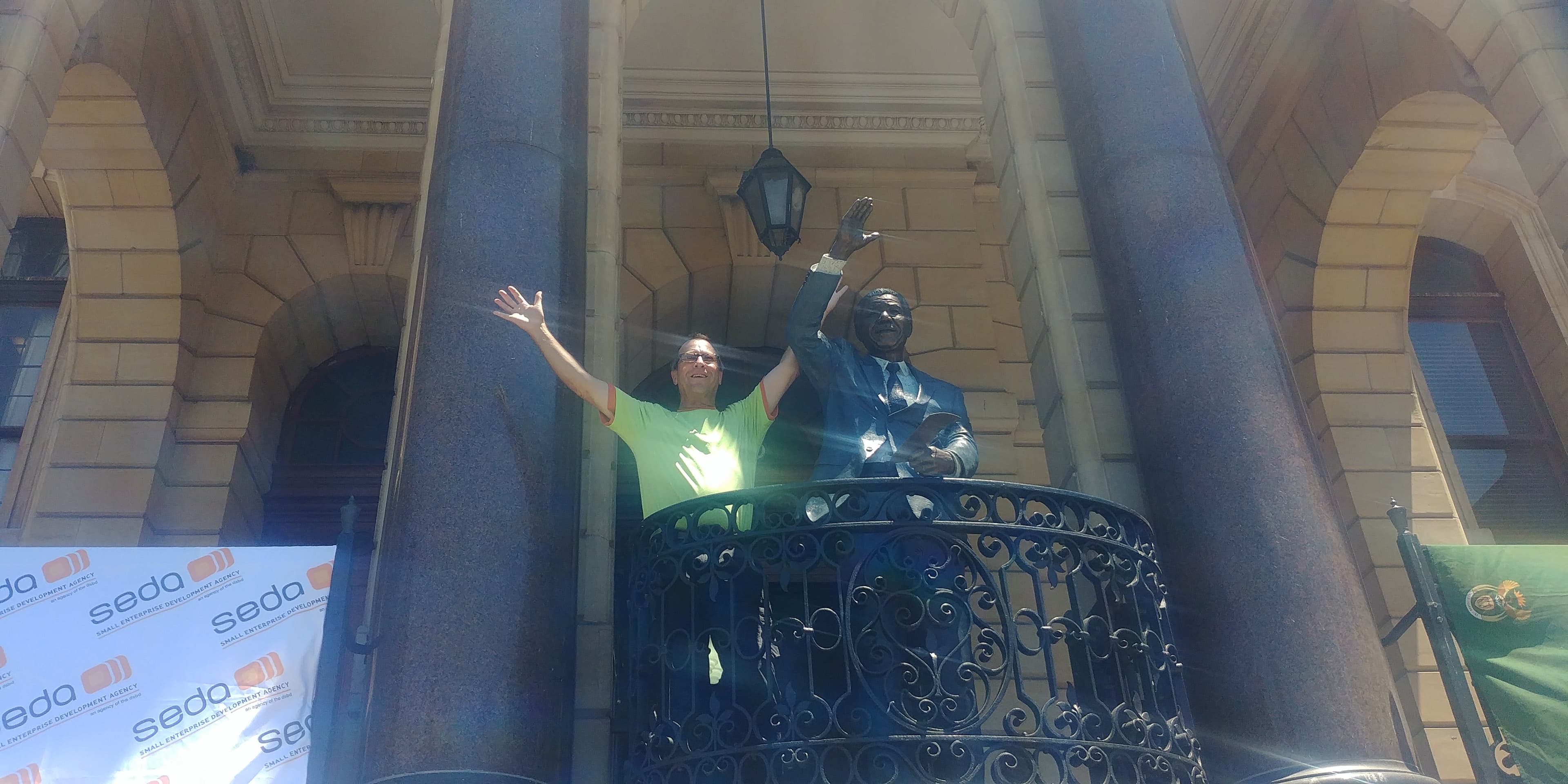 Dr. Nico de Klerk completing the Long Walk at Cape Town City Hall alongside Nelson Mandela statue